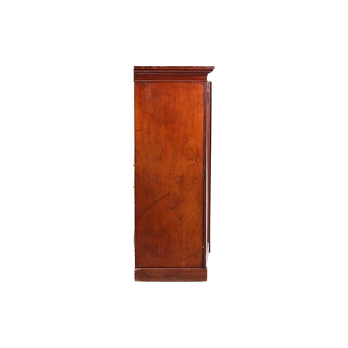 234 - An early Victorian mahogany housekeeper's cupboard, the pair of doors with arched panels opening to ... 