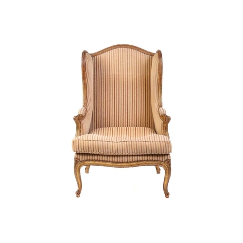 237 - A Louis XV style bergere wing chair, 19th century, with carved wood and gilt gesso frame and striped... 