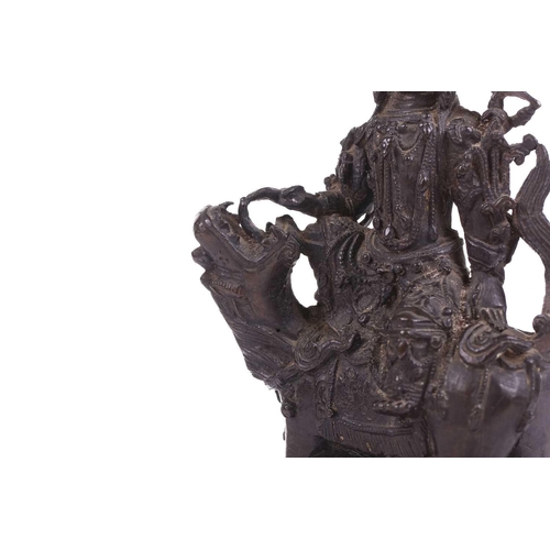 301 - A bronze figure of Bodhisattva Manjushri on a lion, probably 19th century, 23 cm high