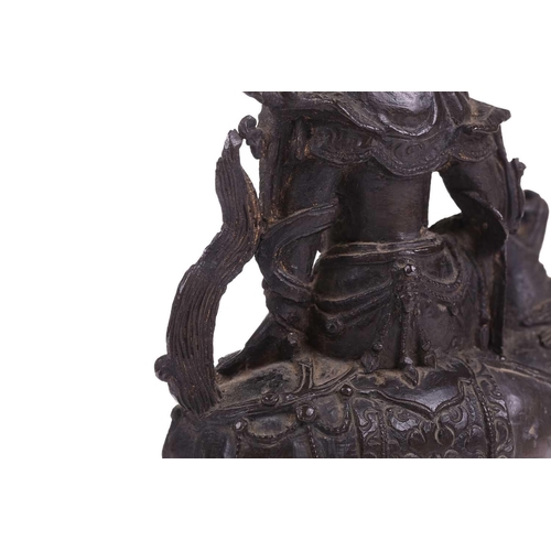 301 - A bronze figure of Bodhisattva Manjushri on a lion, probably 19th century, 23 cm high