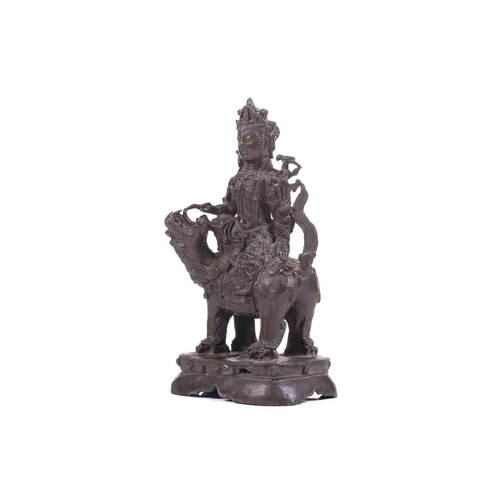 301 - A bronze figure of Bodhisattva Manjushri on a lion, probably 19th century, 23 cm high