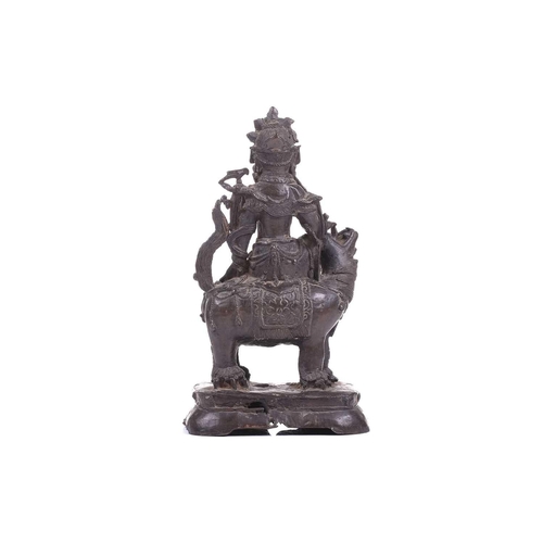 301 - A bronze figure of Bodhisattva Manjushri on a lion, probably 19th century, 23 cm high