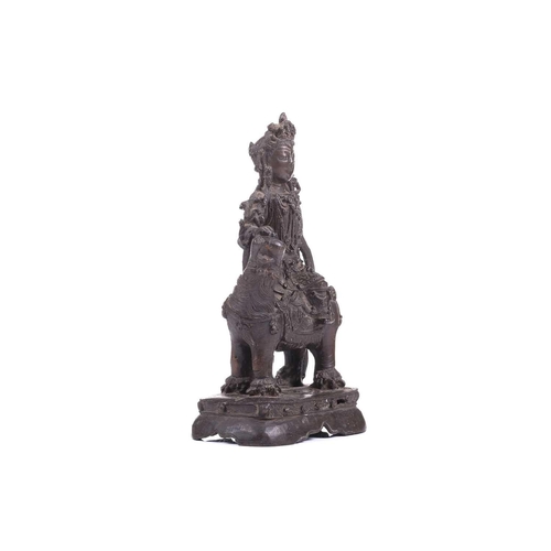 301 - A bronze figure of Bodhisattva Manjushri on a lion, probably 19th century, 23 cm high