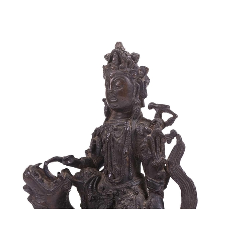 301 - A bronze figure of Bodhisattva Manjushri on a lion, probably 19th century, 23 cm high