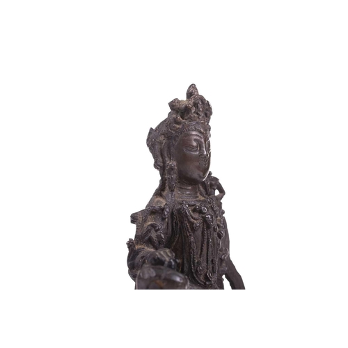 301 - A bronze figure of Bodhisattva Manjushri on a lion, probably 19th century, 23 cm high