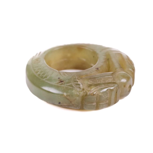 307 - A Chinese carved green/yellow jade pendant ring in the form of a pair of scaley pig dragons contesti... 