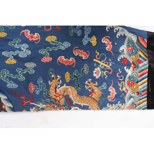 310 - A Chinese silk embroidered Dragon robe, Qing, worked with nine gilt thread dragons each chasing flam... 