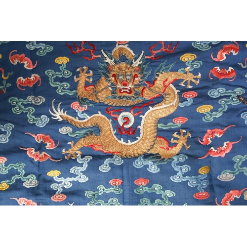 310 - A Chinese silk embroidered Dragon robe, Qing, worked with nine gilt thread dragons each chasing flam... 