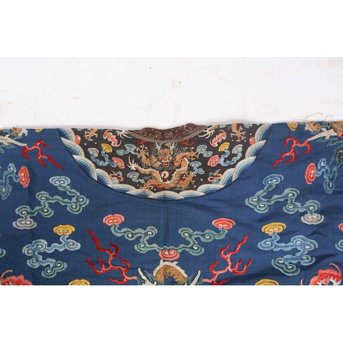 310 - A Chinese silk embroidered Dragon robe, Qing, worked with nine gilt thread dragons each chasing flam... 