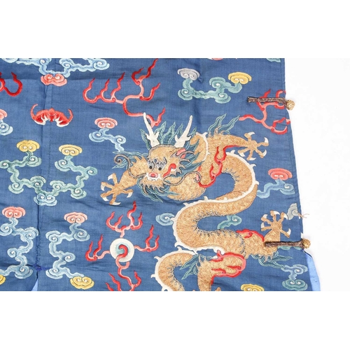 310 - A Chinese silk embroidered Dragon robe, Qing, worked with nine gilt thread dragons each chasing flam... 