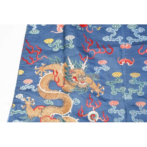 310 - A Chinese silk embroidered Dragon robe, Qing, worked with nine gilt thread dragons each chasing flam... 