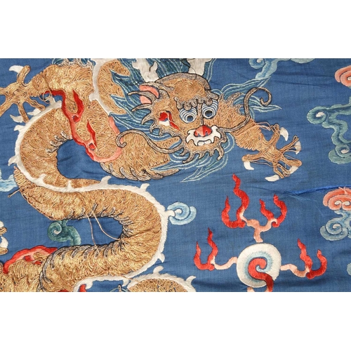 310 - A Chinese silk embroidered Dragon robe, Qing, worked with nine gilt thread dragons each chasing flam... 