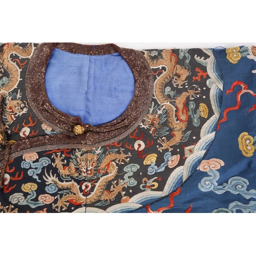 310 - A Chinese silk embroidered Dragon robe, Qing, worked with nine gilt thread dragons each chasing flam... 