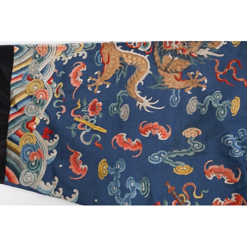 310 - A Chinese silk embroidered Dragon robe, Qing, worked with nine gilt thread dragons each chasing flam... 