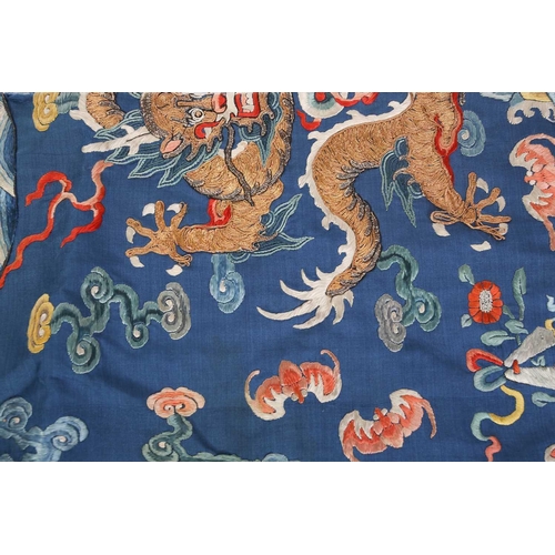 310 - A Chinese silk embroidered Dragon robe, Qing, worked with nine gilt thread dragons each chasing flam... 