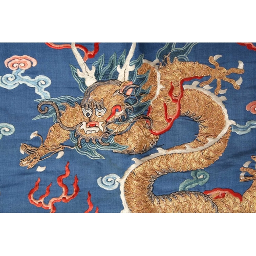 310 - A Chinese silk embroidered Dragon robe, Qing, worked with nine gilt thread dragons each chasing flam... 