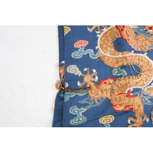 310 - A Chinese silk embroidered Dragon robe, Qing, worked with nine gilt thread dragons each chasing flam... 