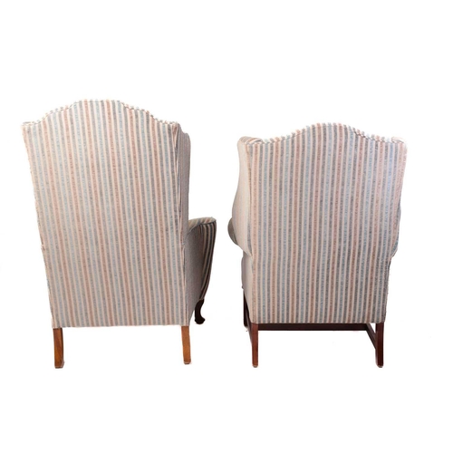 320 - Two George III style wing armchairs, 20th century, each well upholstered in a striped material, one ... 