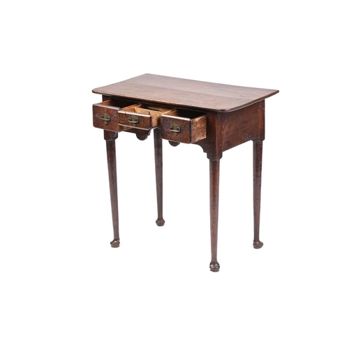 325 - An early 18th-century oak three-drawer side table with turned legs terminating in pad feet. 67 cm wi... 