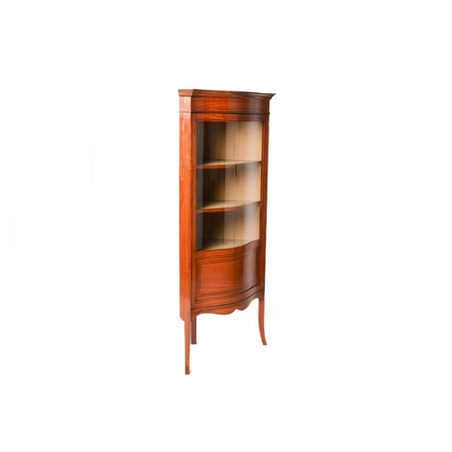 337 - An Edwardian figured satinwood corner vitrine with single serpentine glazed door, with satinwood and... 