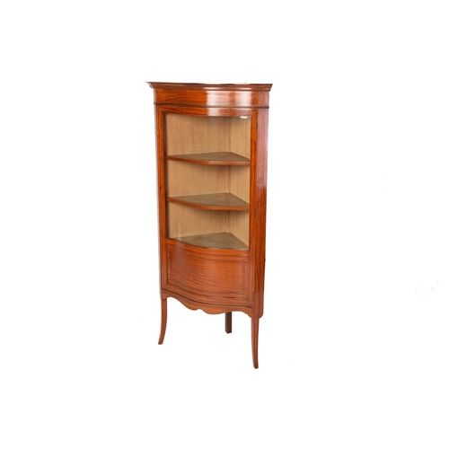 337 - An Edwardian figured satinwood corner vitrine with single serpentine glazed door, with satinwood and... 