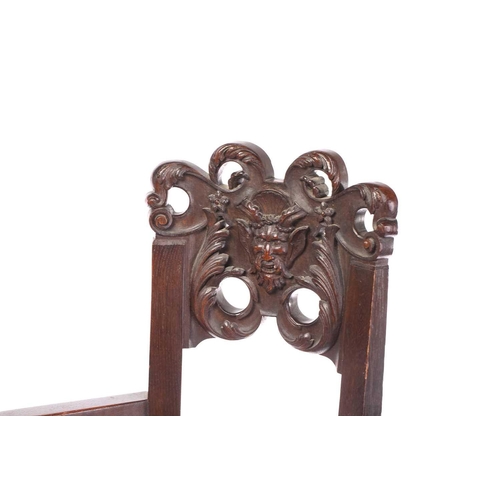 344 - A pair of French carved oak caquetoire armchairs, 19th/20th century, the curved backs carved and pie... 