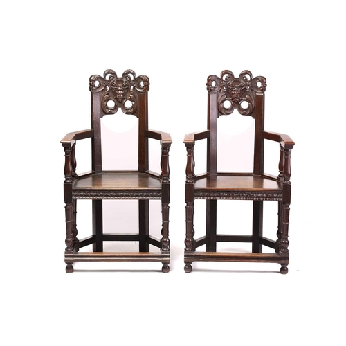 344 - A pair of French carved oak caquetoire armchairs, 19th/20th century, the curved backs carved and pie... 