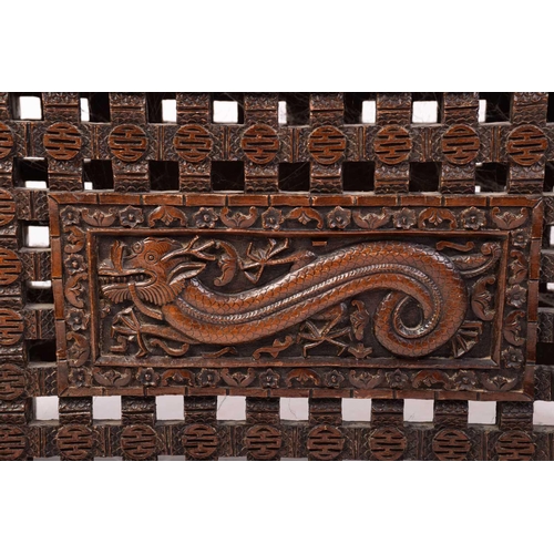 357 - A Chinese carved hardwood centre table, the rectangular top carved with dragons and bats over a simi... 