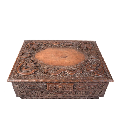 357 - A Chinese carved hardwood centre table, the rectangular top carved with dragons and bats over a simi... 