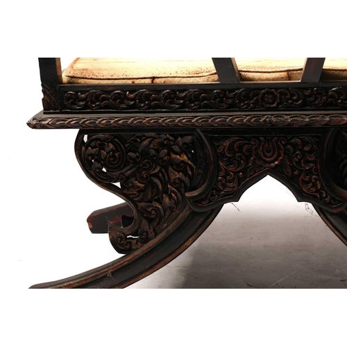 359 - A Burmese carved and red lacquered Howdar seat (elephant seat), 20th century with scroll back and sh... 