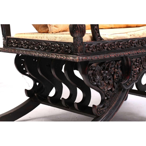 359 - A Burmese carved and red lacquered Howdar seat (elephant seat), 20th century with scroll back and sh... 