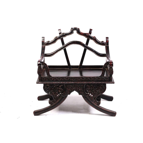 359 - A Burmese carved and red lacquered Howdar seat (elephant seat), 20th century with scroll back and sh... 