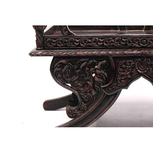 359 - A Burmese carved and red lacquered Howdar seat (elephant seat), 20th century with scroll back and sh... 