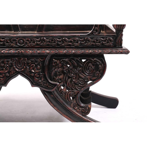 359 - A Burmese carved and red lacquered Howdar seat (elephant seat), 20th century with scroll back and sh... 