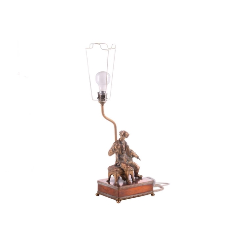 364 - A 20th-century copper and gilt brass figural table lamp, modelled a seated dandy, 68 cm high to incl... 