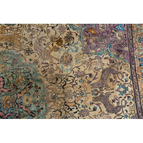 365 - An antique Kashan silk on-silk rug with a central medalion on an ivory ground filled with deer, bird... 