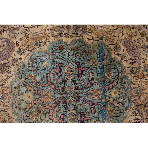 365 - An antique Kashan silk on-silk rug with a central medalion on an ivory ground filled with deer, bird... 