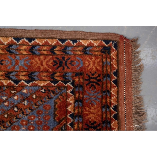 367 - A large brick red/brown ground Qashqai rug with blue St. Andrew's cross filled diamond pattern withi... 