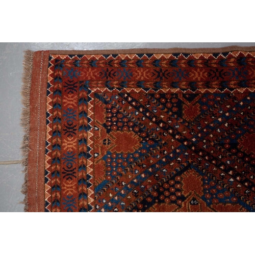 367 - A large brick red/brown ground Qashqai rug with blue St. Andrew's cross filled diamond pattern withi... 