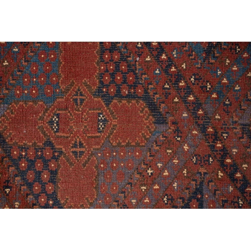 367 - A large brick red/brown ground Qashqai rug with blue St. Andrew's cross filled diamond pattern withi... 