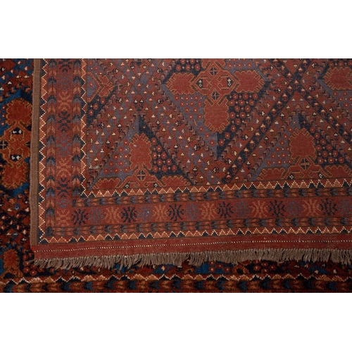 367 - A large brick red/brown ground Qashqai rug with blue St. Andrew's cross filled diamond pattern withi... 