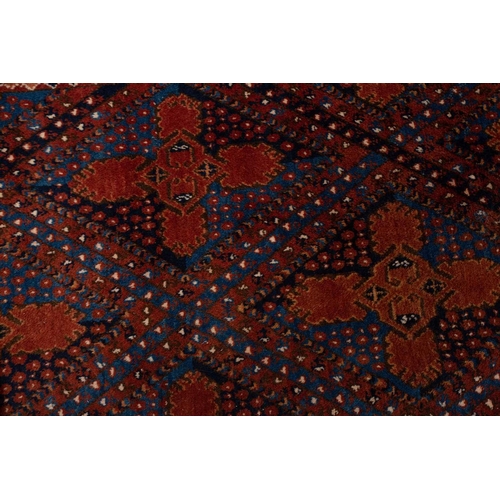 367 - A large brick red/brown ground Qashqai rug with blue St. Andrew's cross filled diamond pattern withi... 