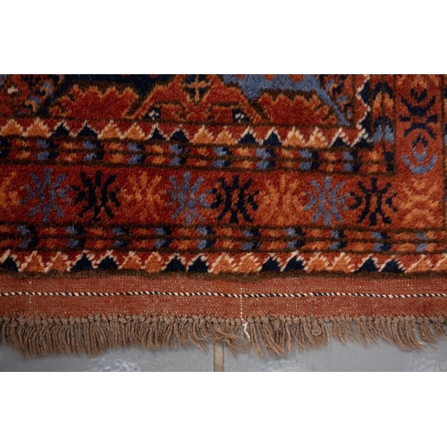 367 - A large brick red/brown ground Qashqai rug with blue St. Andrew's cross filled diamond pattern withi... 