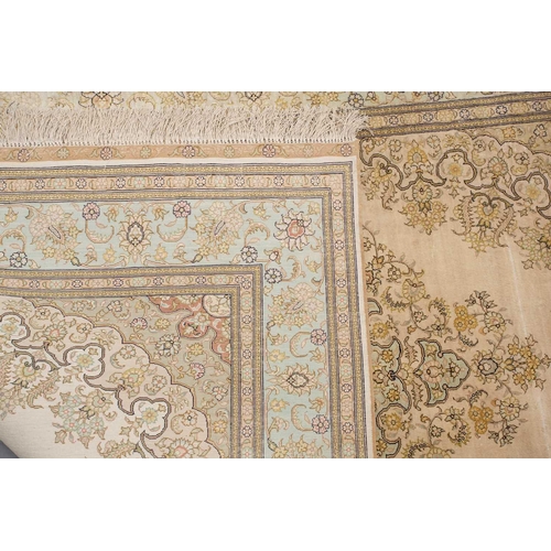 368 - A faded ivory ground Qum silk on silk rug, 20th century, with a central medallion and corners, 184 c... 