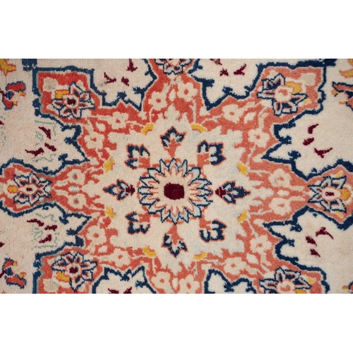 369 - An ivory ground Isfahan rug, with central star boss and hanging lanterns, signed within the Persian ... 