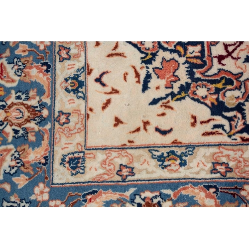 369 - An ivory ground Isfahan rug, with central star boss and hanging lanterns, signed within the Persian ... 