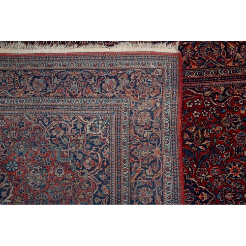 371 - A Kashan rug, with central mandorla and lanterns on a red ground, within palmette borders 202cm x 13... 