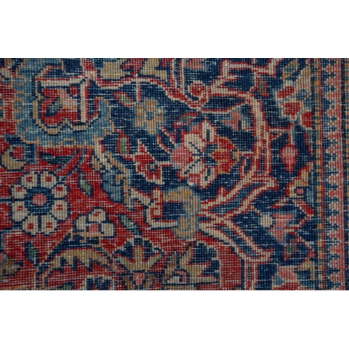 371 - A Kashan rug, with central mandorla and lanterns on a red ground, within palmette borders 202cm x 13... 