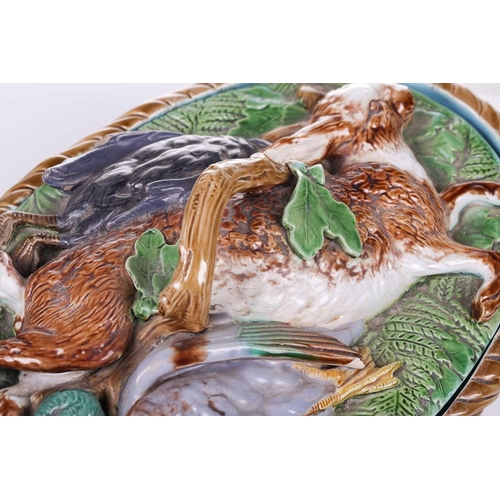 397 - A Minton Majolica pattern 668 game pie dish, liner and cover bearing the date cypher for 1868, the c... 