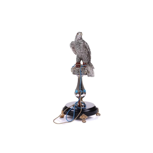 422 - Lorenzo Sandomar, a large model of a silver and gold plated falcon, marked 925, standing on a facete... 